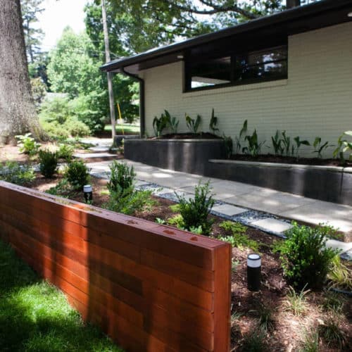 Sloping front yard modern landscape with mixed materials