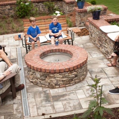 Family gathering patio space with custom fire pit, brick, stone, concrete pavers