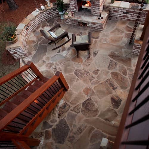 Flagstone patio with brick seatwall and fireplace