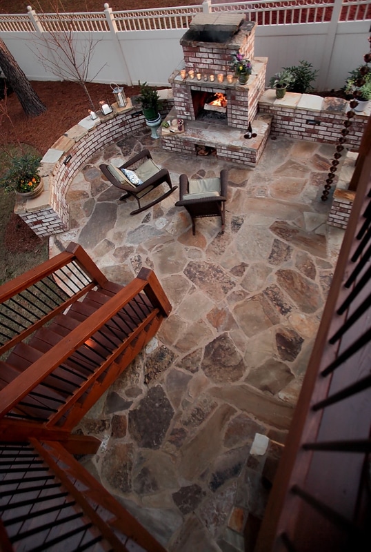 Flagstone patio with brick seatwall and fireplace