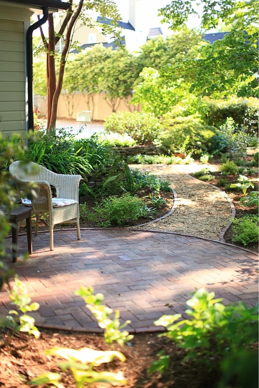 Circular brick patio with gravel pathway