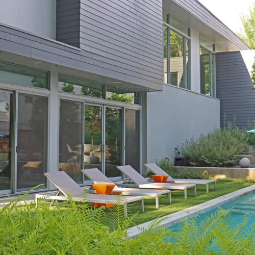 Modern backyard pool and lounge area