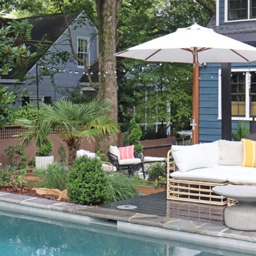Outdoor poolside seating and cafe string lights