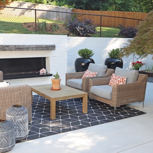 Modern concrete patio with custom brick fireplace